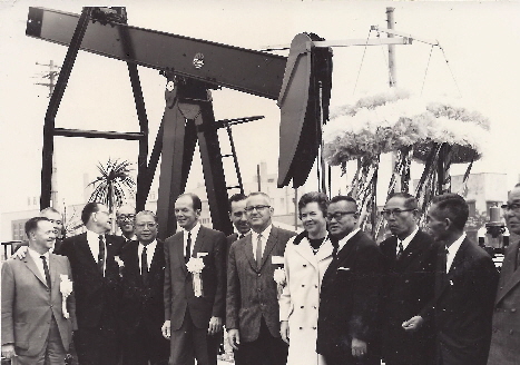 1966 LB Officials in Yokkaichi Posing with LB's Gift to Yokkaichi, an Oil Derrick Replica.